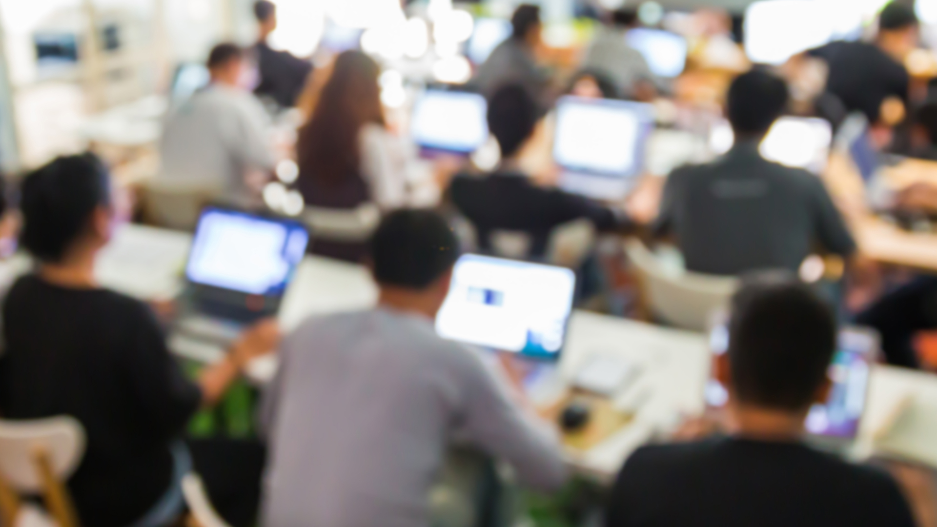 Blurred photo of employees in computer training room