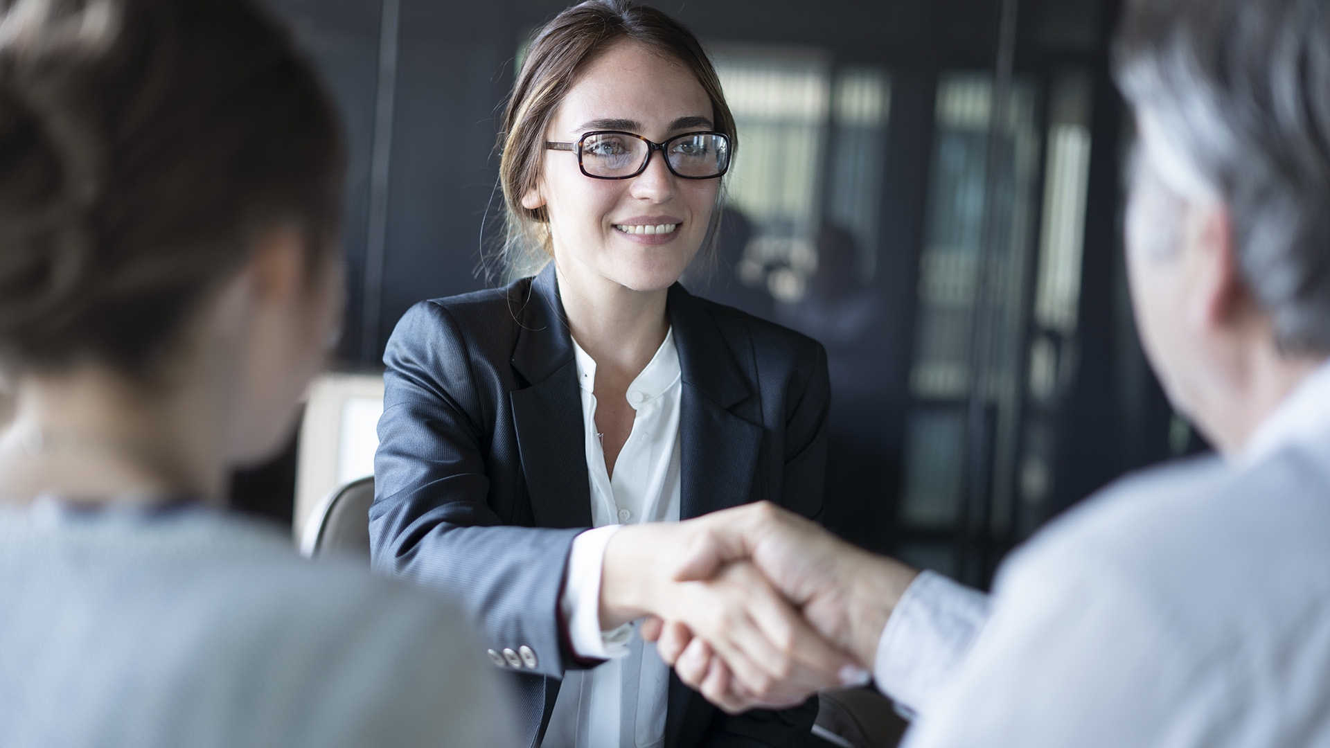 Business woman shaking hands with clients